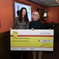 two women holding oversized cheque