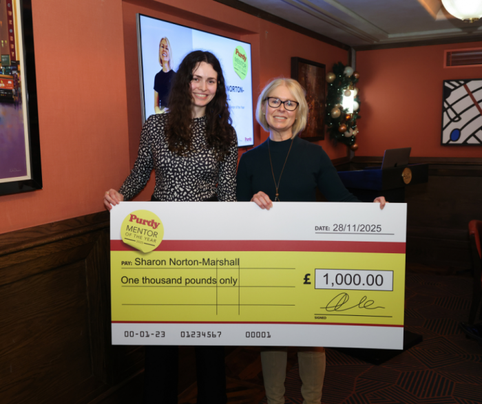 two women holding oversized cheque